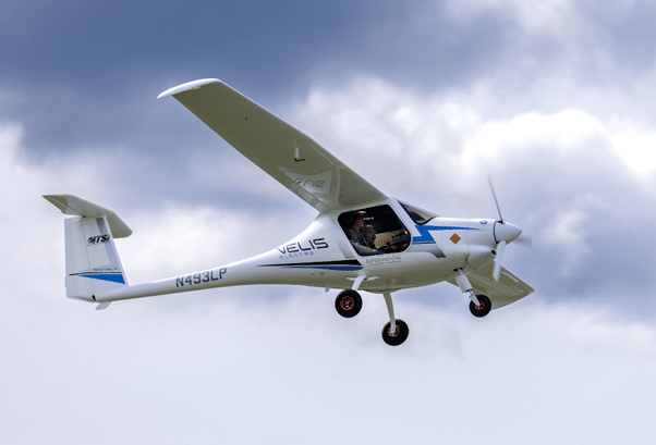 Pipistrel Velis Electro fully-electric light sport aircraft flying with clouds behind