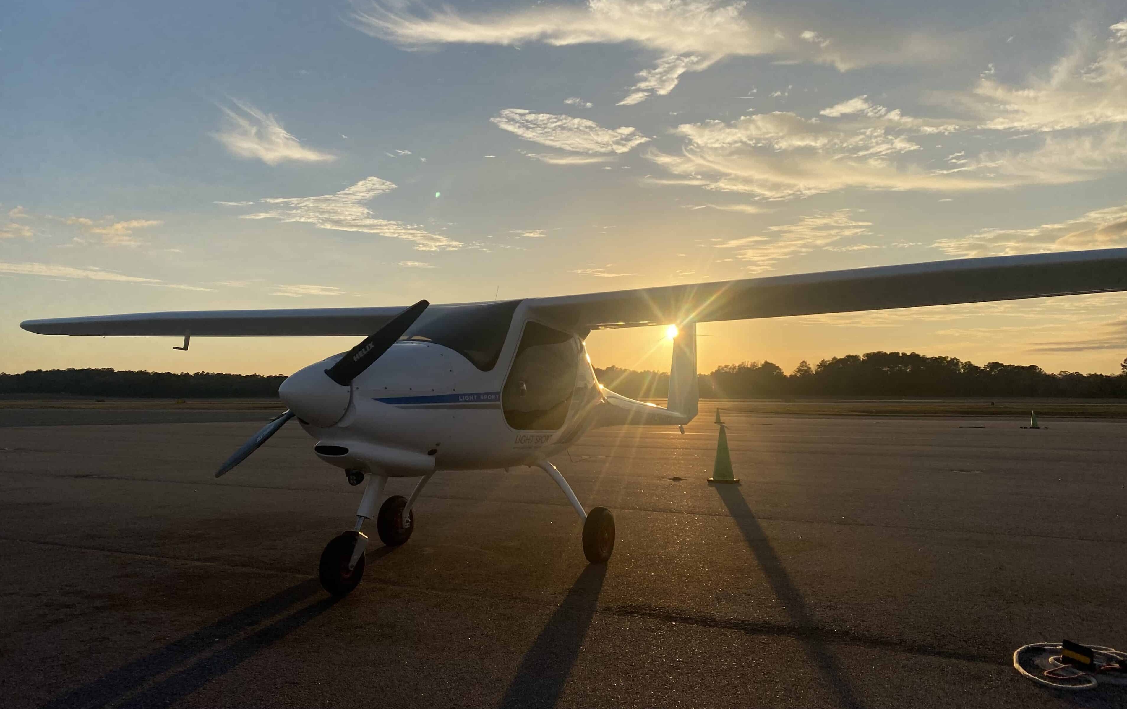 Alpha Trainer on ground with sunset in background